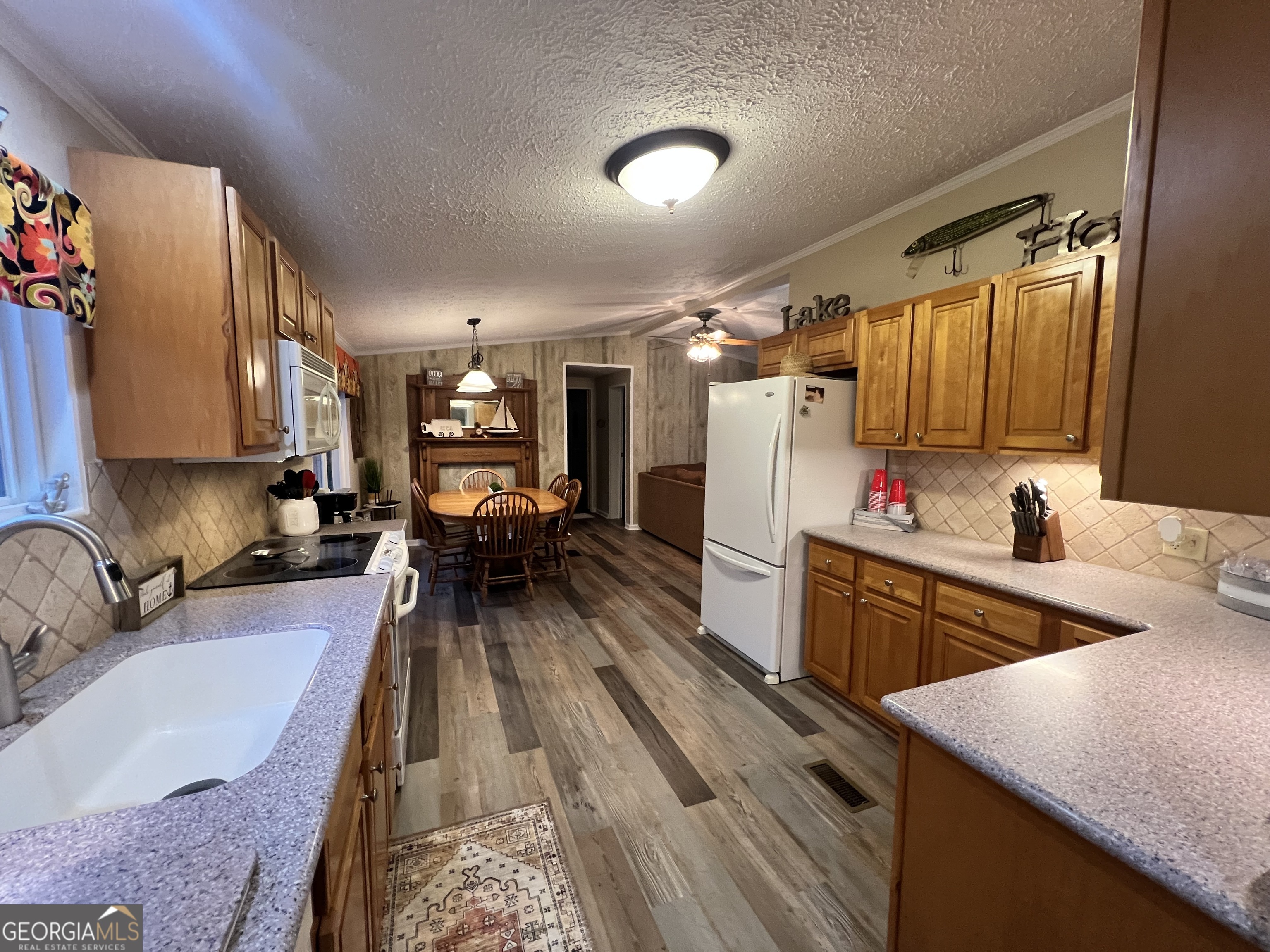64 Bay Point Sparta, GA 31087 - Photo 26 of 53 a kitchen with granite countertop lots of counter top space and stainless steel appliances