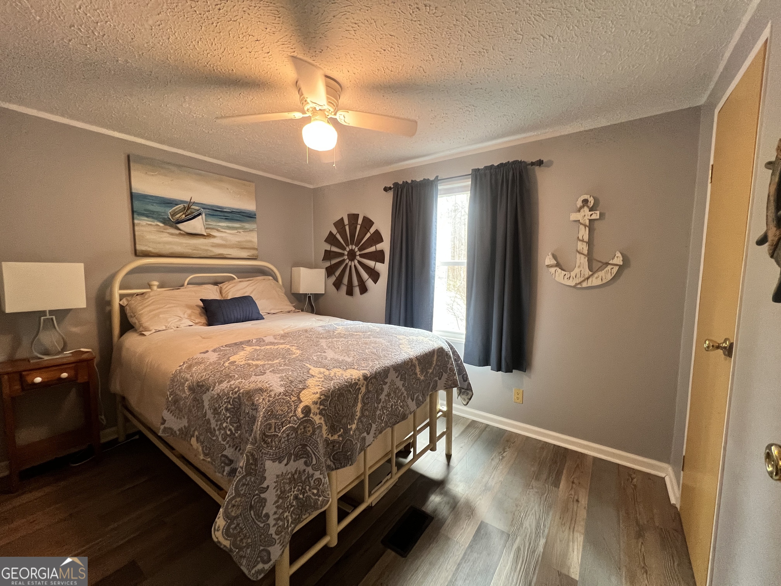 64 Bay Point Sparta, GA 31087 - Photo 31 of 53 a bedroom with a large bed and a chandelier