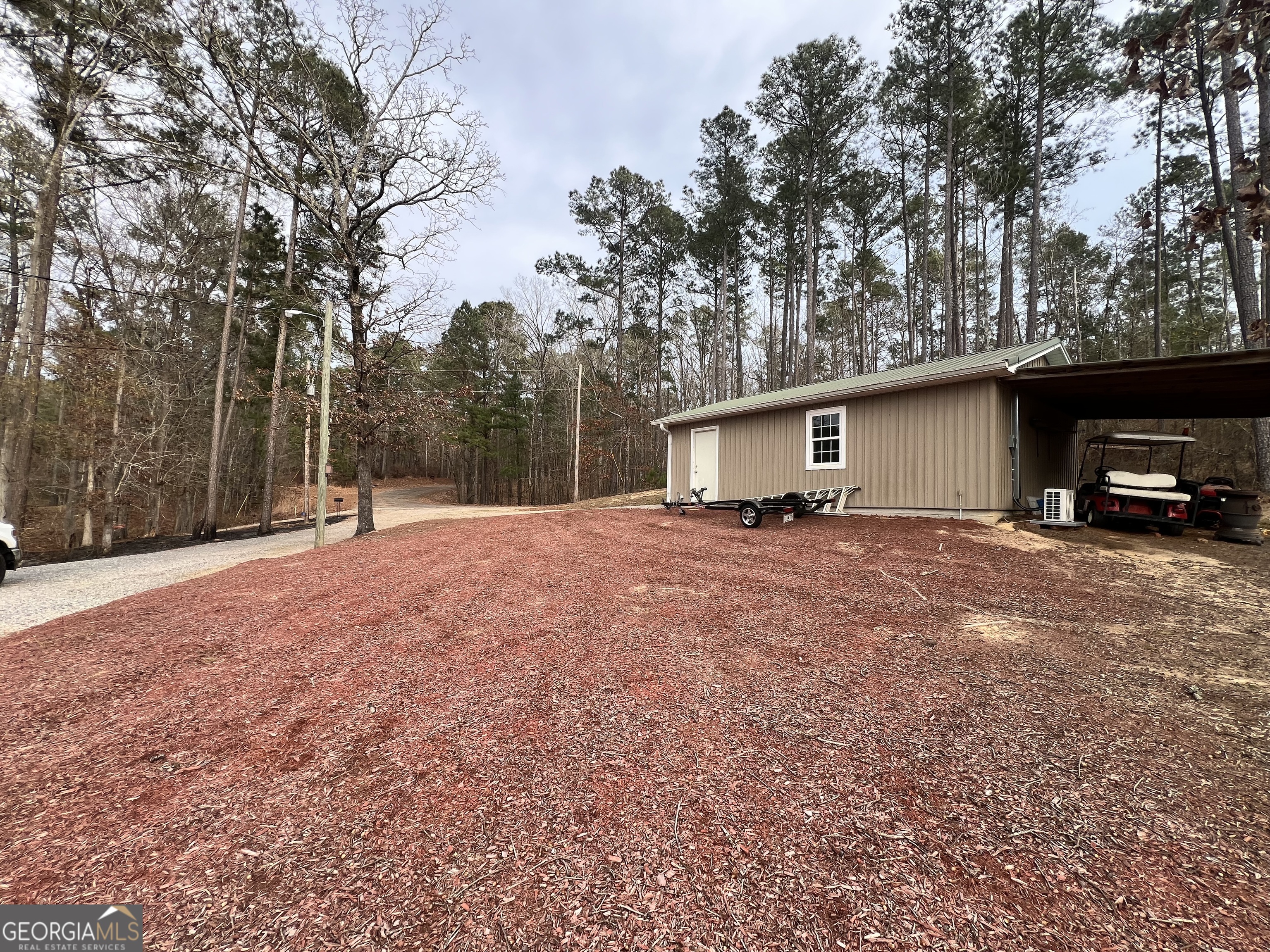 64 Bay Point Sparta, GA 31087 - Photo 45 of 53 a view of a house with a large tree and a road