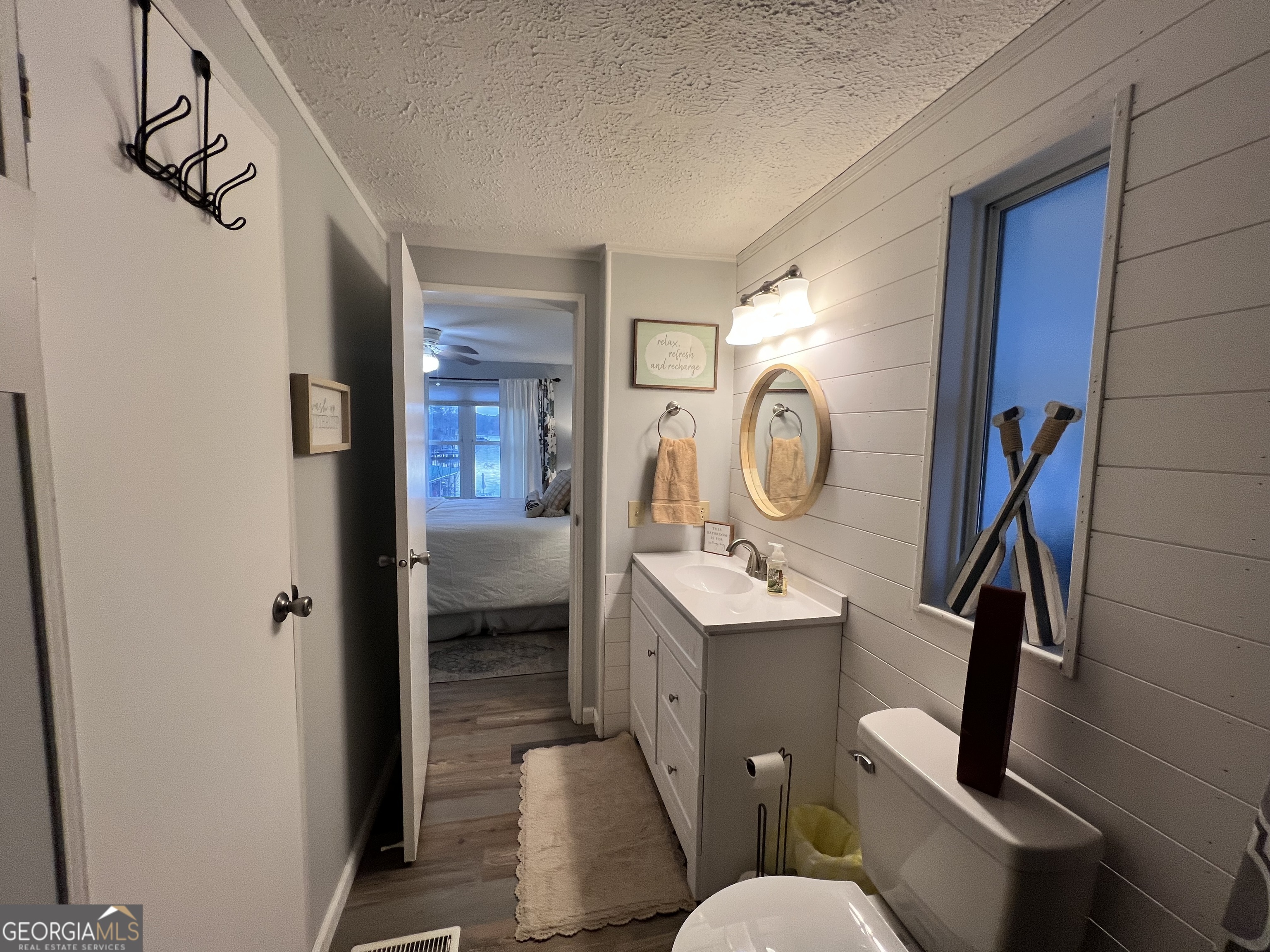 64 Bay Point Sparta, GA 31087 - Photo 10 of 53 a bathroom with a toilet a sink and mirror