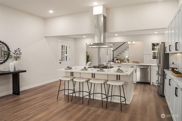 a kitchen with a table chairs stove and cabinets