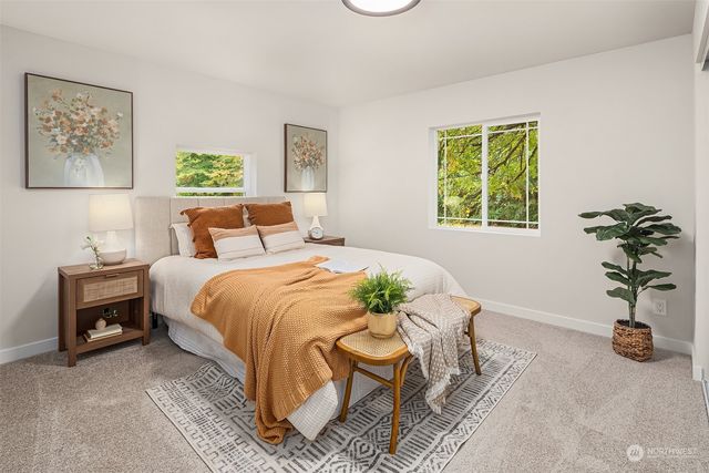 a bed room with a bed and a chair