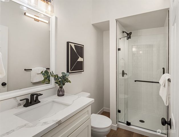 a bathroom with a sink toilet and shower