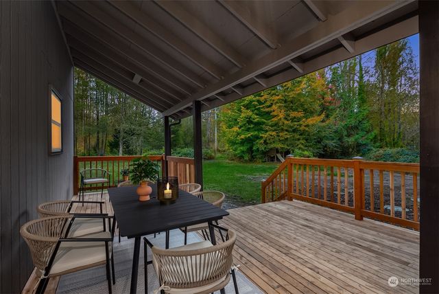 a view of a patio with a table chairs and a backyard