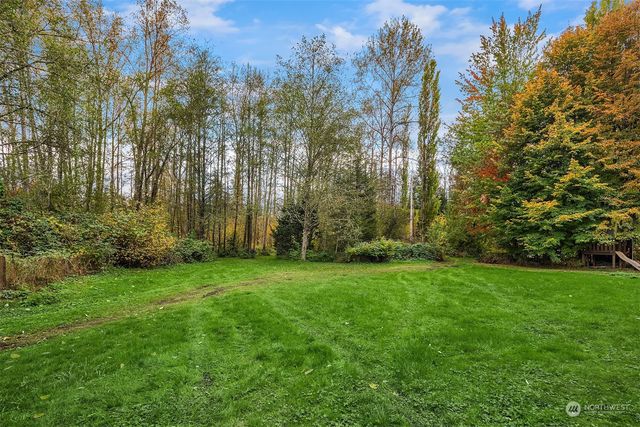 a view of a yard with a house in the background