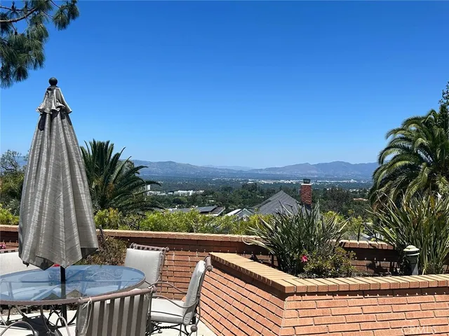 a view of a patio with a table and chairs
