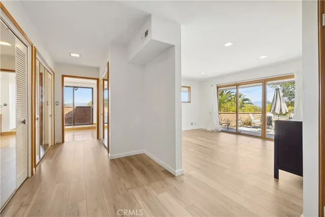 a view of a room with wooden floor and a window