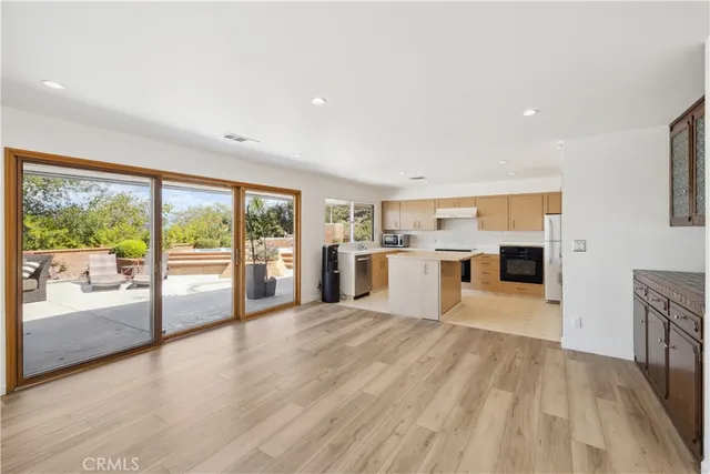 a big room with wooden floor and windows