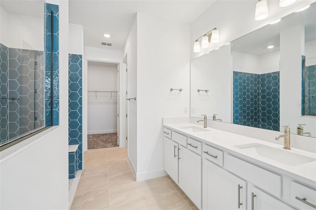 5236 Southwest 88th Circle Ocala, FL 34481 - Photo 13 of 29 a spacious bathroom with a double vanity sink a mirror and a shower