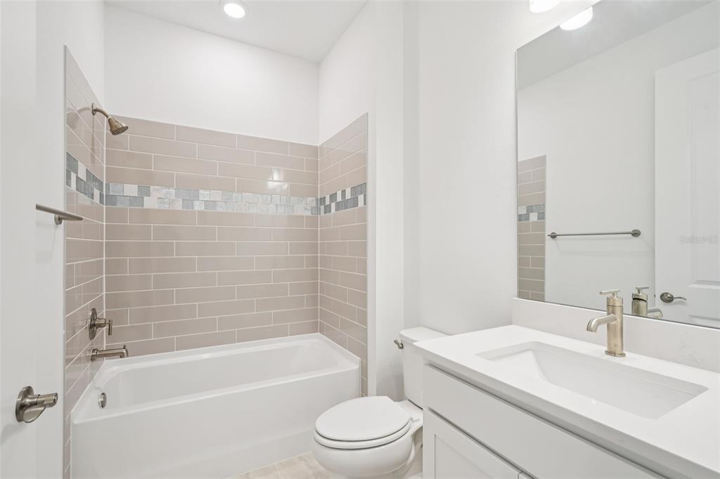 5236 Southwest 88th Circle Ocala, FL 34481 - Photo 24 of 29 a bathroom with a bathtub shower sink vanity mirror and toilet