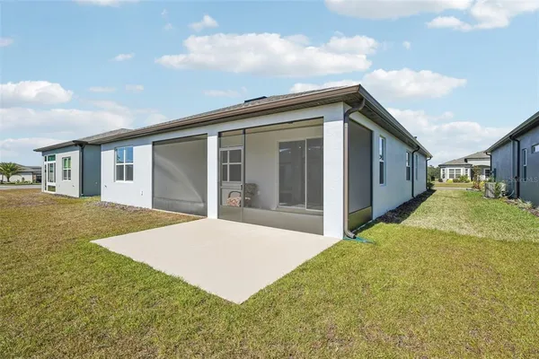 a view of a house with a backyard