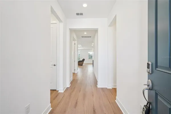 a view of a hallway with wooden floor