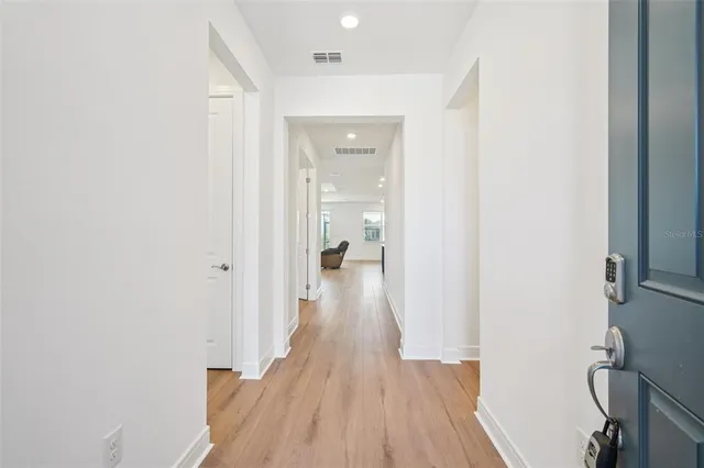 a view of a hallway with wooden floor