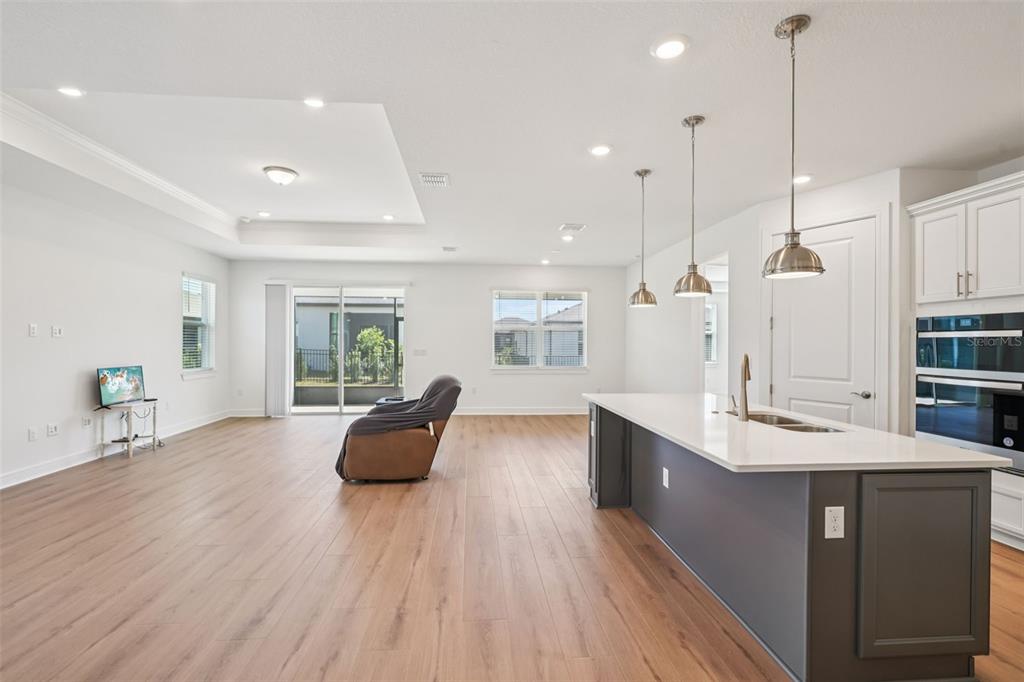 5236 Southwest 88th Circle Ocala, FL 34481 - Photo 5 of 29 a large kitchen with kitchen island granite countertop a large counter top stainless steel appliances and wooden floor