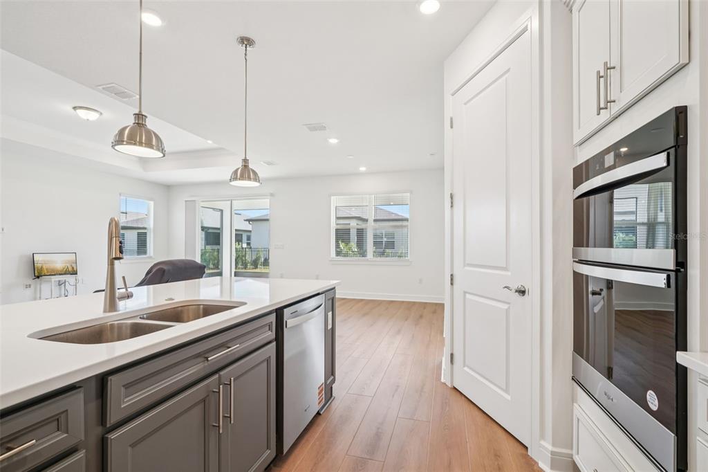 5236 Southwest 88th Circle Ocala, FL 34481 - Photo 9 of 29 a kitchen with stainless steel appliances granite countertop a sink a oven and wooden floors