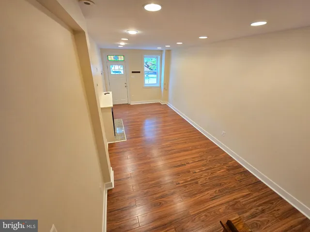 a view of a hallway with wooden floor