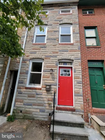 a view of front door of house with stairs