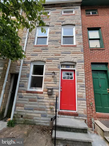 a view of front door of house with stairs