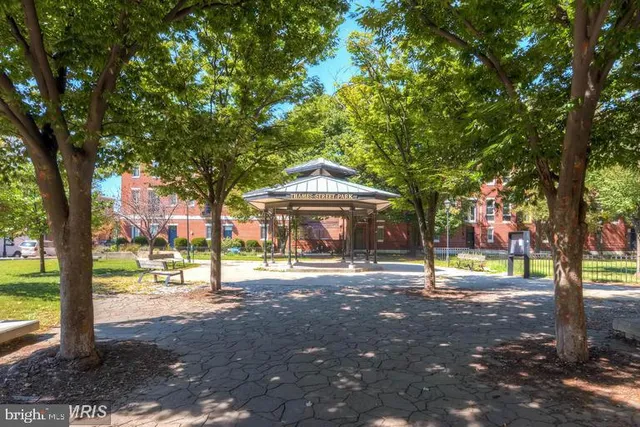 a view of a house with a tree in the background