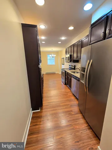 a kitchen with stainless steel appliances a refrigerator and a stove top oven
