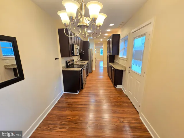 a view of a dining room with wooden floor
