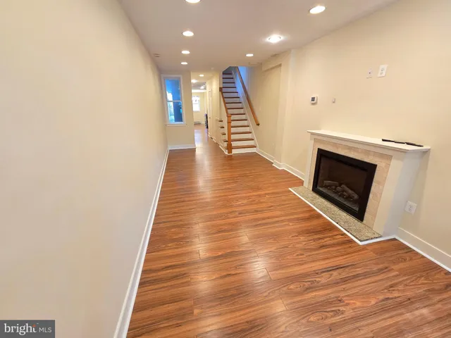 a view of a hallway with wooden floor