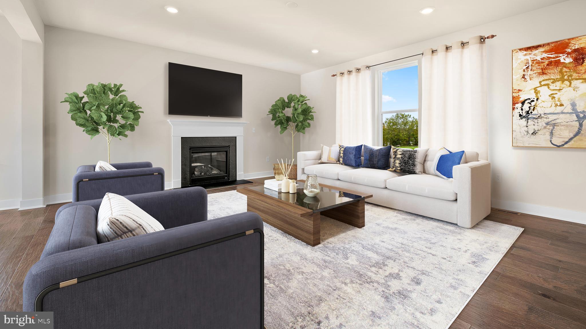 1153 Mariwill Drive Quakertown, PA 18951 - Photo 6 of 14 a living room with furniture a fireplace and a flat screen tv