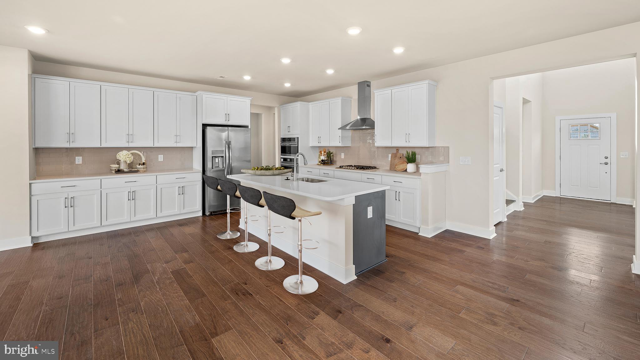 1153 Mariwill Drive Quakertown, PA 18951 - Photo 7 of 14 a kitchen with wooden floors and white cabinets