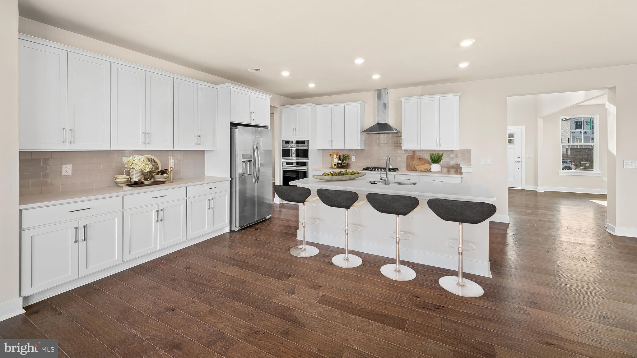 1153 Mariwill Drive Quakertown, PA 18951 - Photo 8 of 14 a kitchen with white cabinets and white appliances