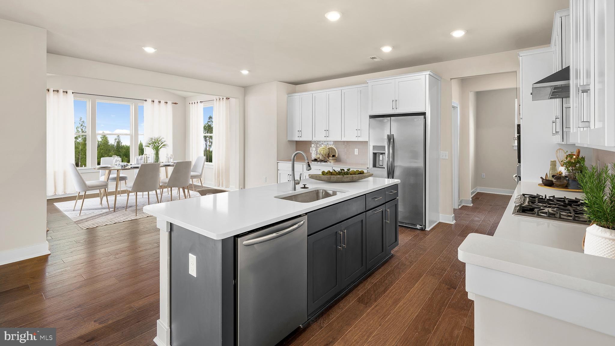 1153 Mariwill Drive Quakertown, PA 18951 - Photo 10 of 14 a kitchen with stainless steel appliances granite countertop a refrigerator a sink dishwasher a stove and white cabinets with wooden floor