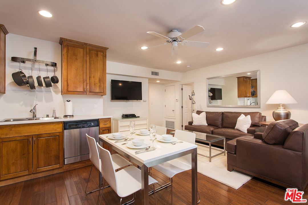 a living room with stainless steel appliances kitchen island granite countertop furniture and a view of kitchen