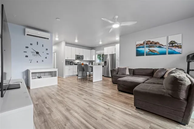 a living room with furniture and kitchen view