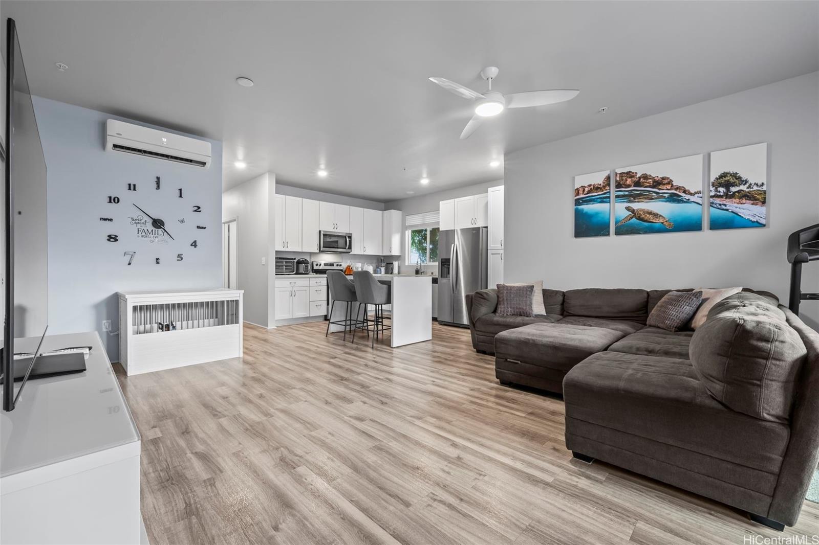 a living room with furniture and kitchen view