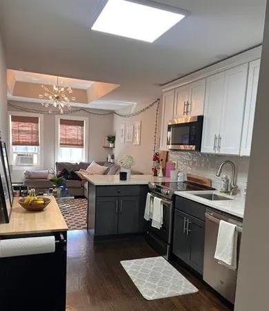 a kitchen with a sink a stove and cabinets