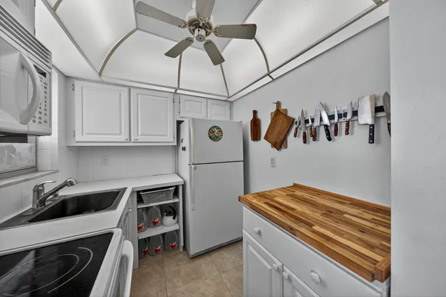 a kitchen with stainless steel appliances a stove a refrigerator and cabinets