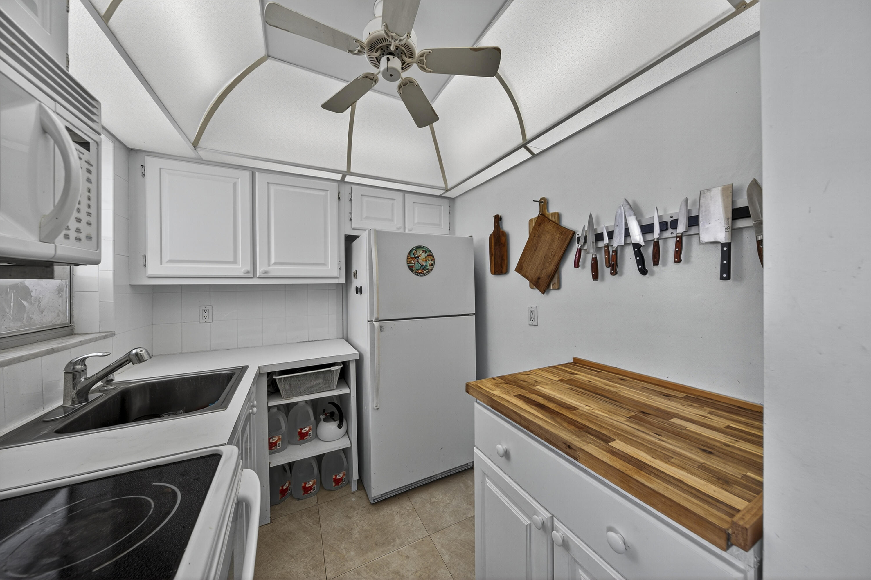a kitchen with stainless steel appliances a stove a refrigerator and cabinets