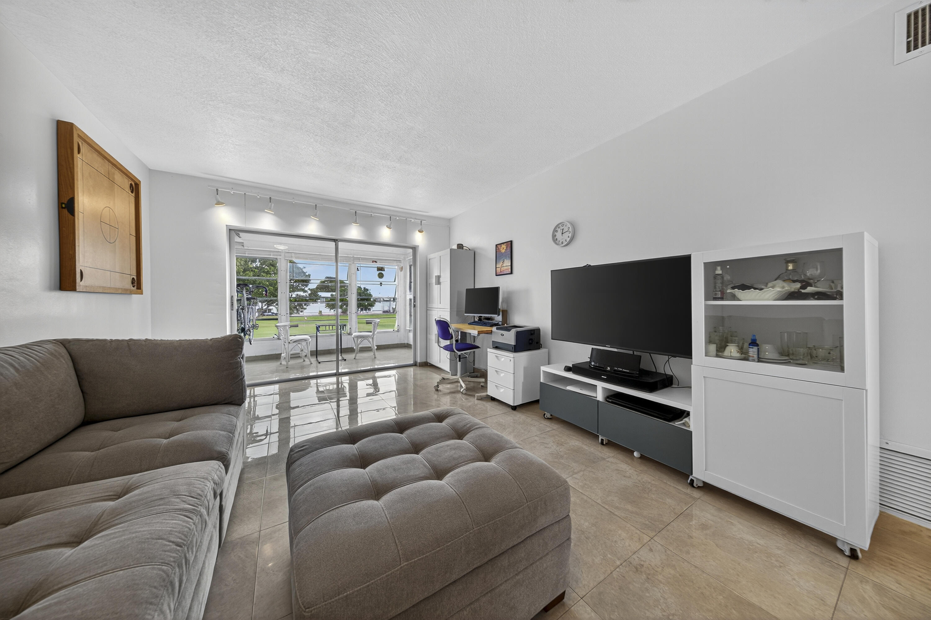 251 South Golf Boulevard, Unit 287 Pompano Beach, FL 33064 - Photo 12 of 63 a living room with furniture and a flat screen tv