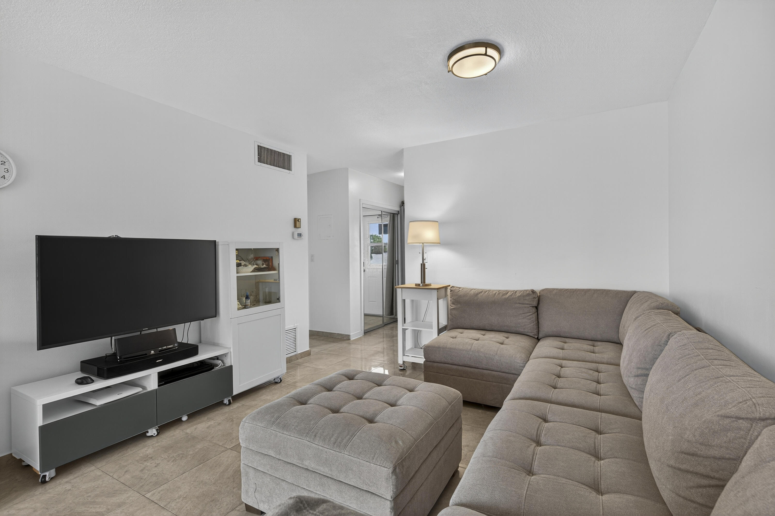 251 South Golf Boulevard, Unit 287 Pompano Beach, FL 33064 - Photo 15 of 63 a living room with furniture and a flat screen tv