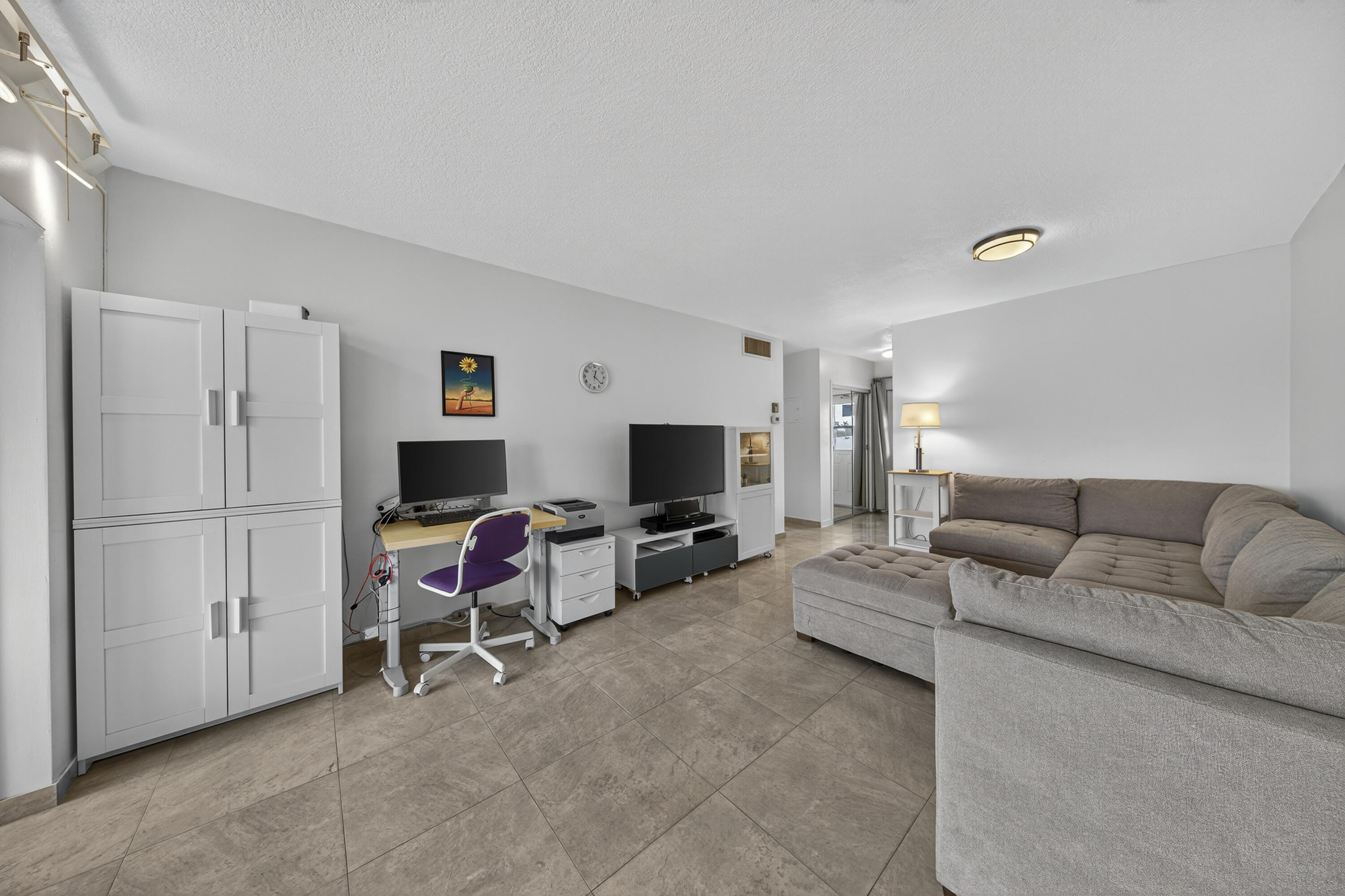 251 South Golf Boulevard, Unit 287 Pompano Beach, FL 33064 - Photo 16 of 63 a living room with furniture and a flat screen tv