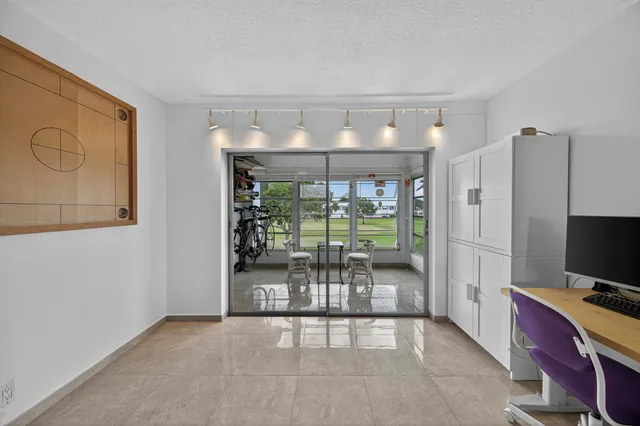 a view of a livingroom with wooden floor and windows