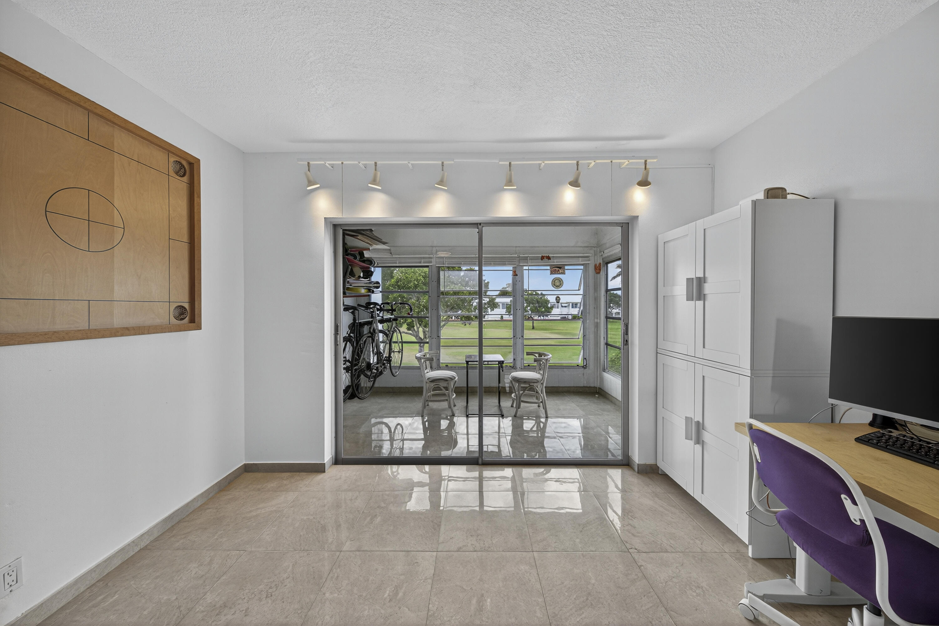 251 South Golf Boulevard, Unit 287 Pompano Beach, FL 33064 - Photo 18 of 63 a dining room with furniture and a floor to ceiling window