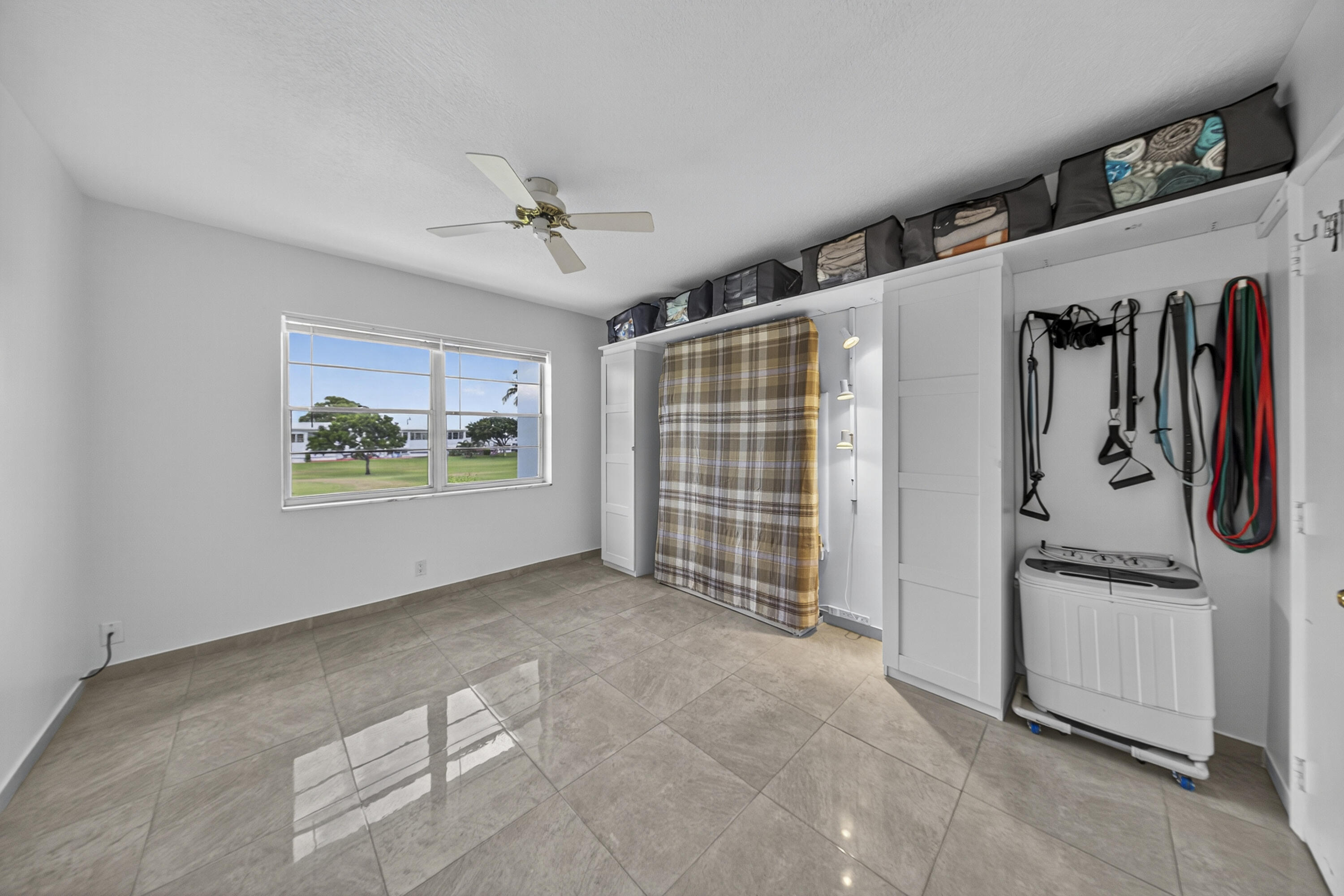 251 South Golf Boulevard, Unit 287 Pompano Beach, FL 33064 - Photo 19 of 63 a view of a livingroom with wooden floor and windows