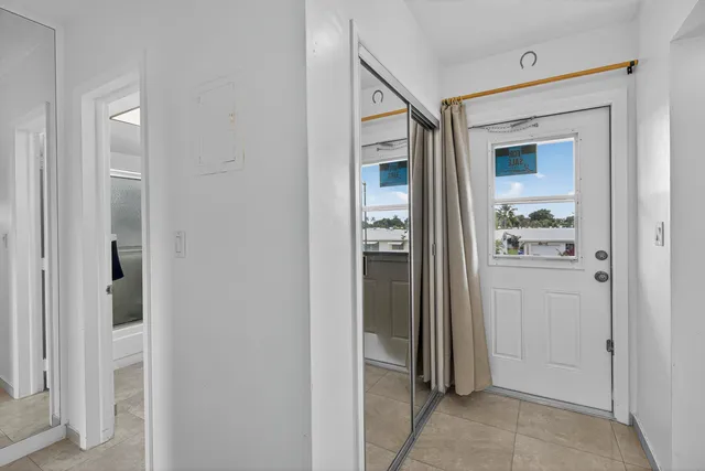 an aerial view of a city with lots of residential buildings and ocean view in back