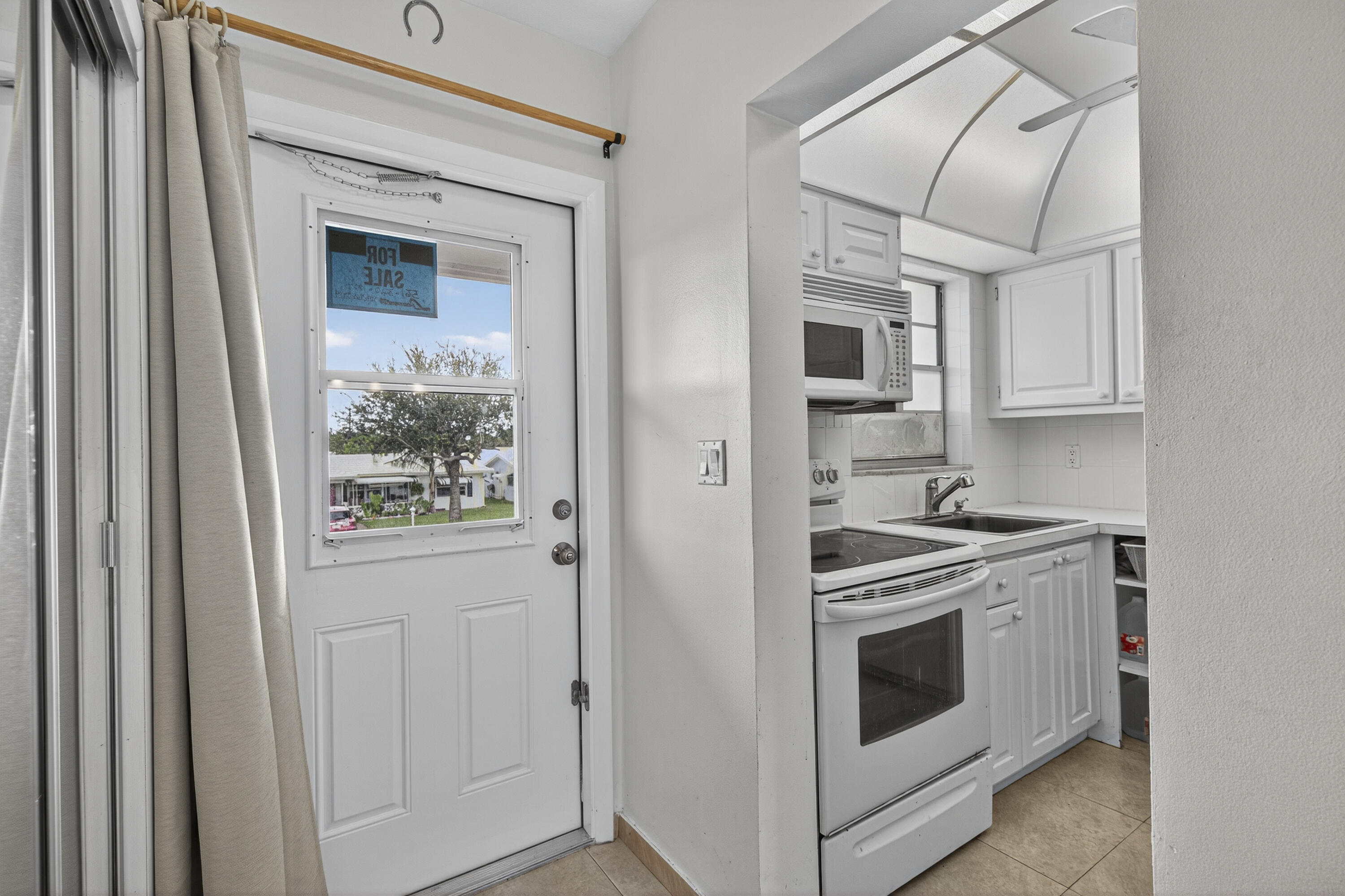 251 South Golf Boulevard, Unit 287 Pompano Beach, FL 33064 - Photo 26 of 63 a kitchen with stainless steel appliances granite countertop white cabinets and stove top oven