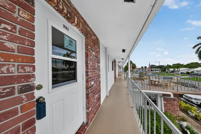 a view of a swimming pool with an outdoor seating and a lots of residential buildings