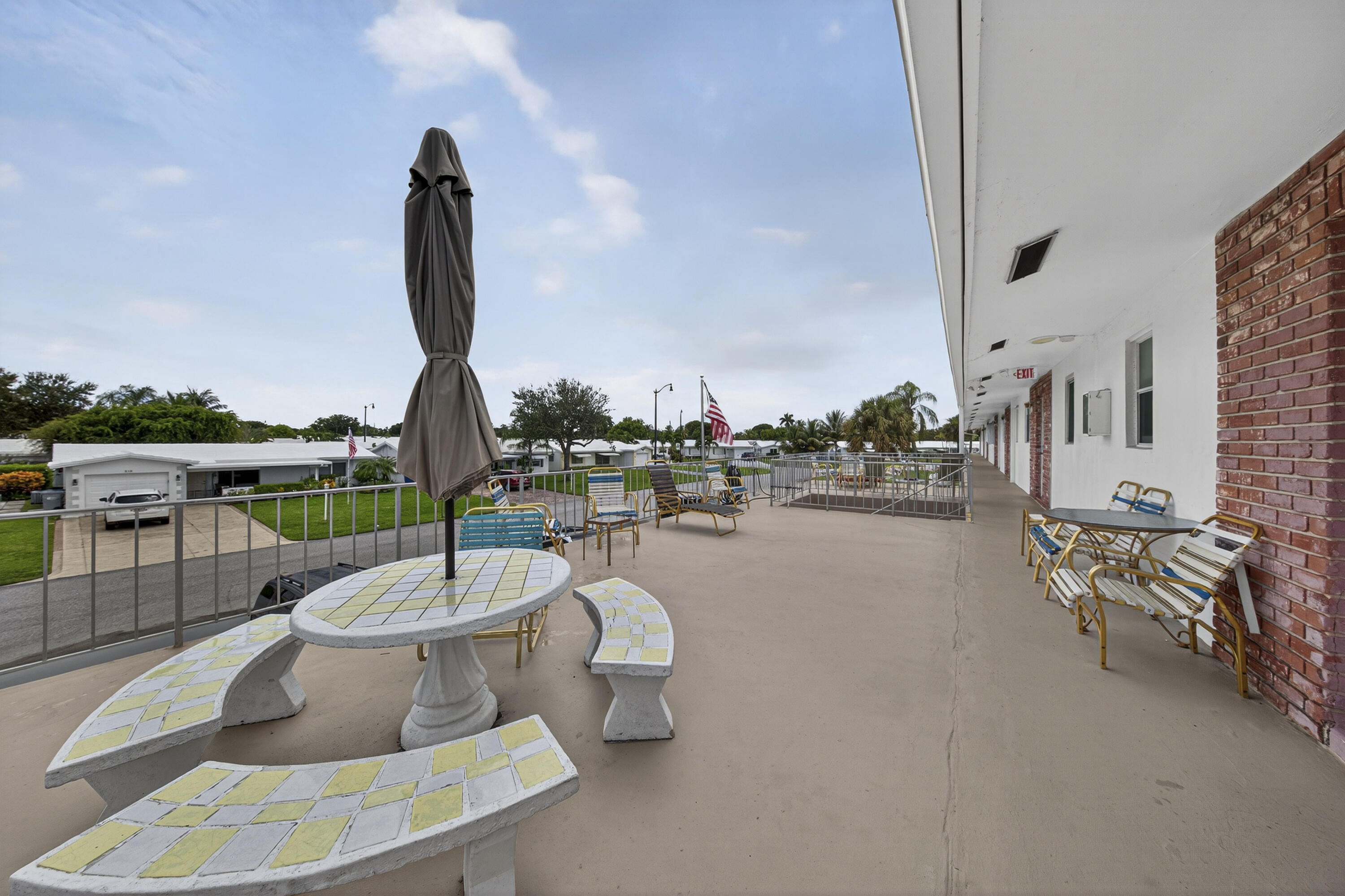 251 South Golf Boulevard, Unit 287 Pompano Beach, FL 33064 - Photo 30 of 63 a view of a swimming pool with outdoor seating and city view