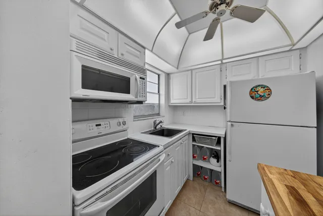 a kitchen with stainless steel appliances a stove microwave and a refrigerator
