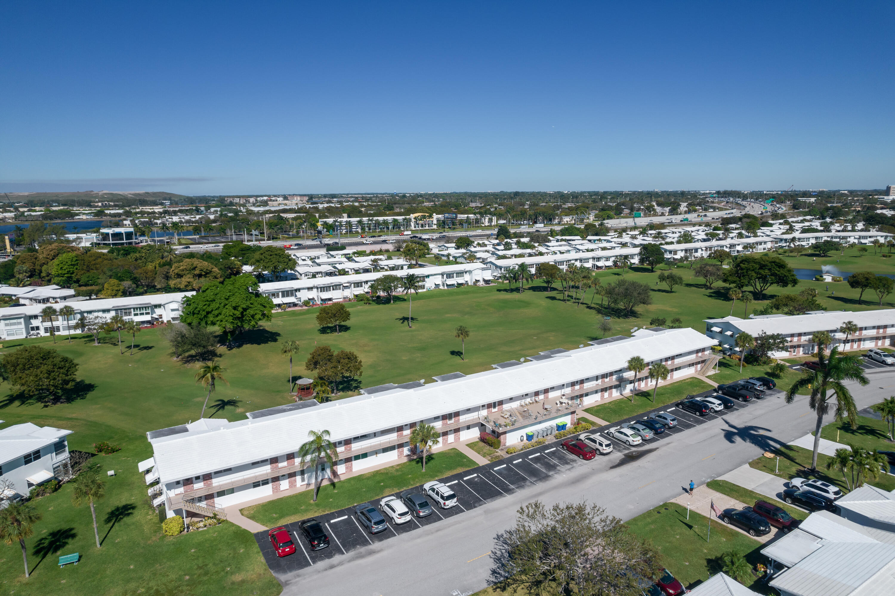 251 South Golf Boulevard, Unit 287 Pompano Beach, FL 33064 - Photo 33 of 63 an aerial view of a city with lots of residential buildings and ocean view in back