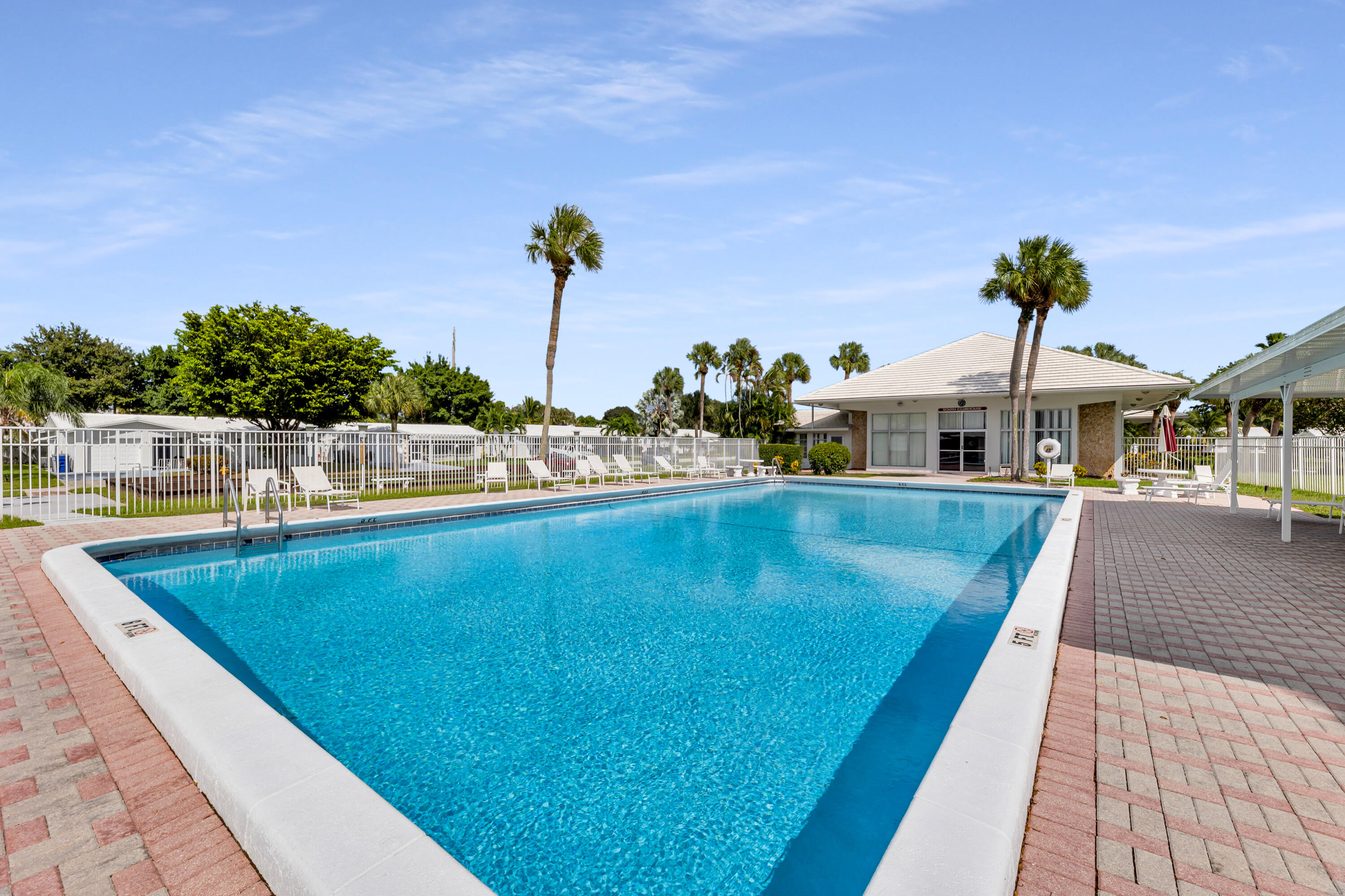 251 South Golf Boulevard, Unit 287 Pompano Beach, FL 33064 - Photo 51 of 63 a view of a swimming pool with a lounge chairs