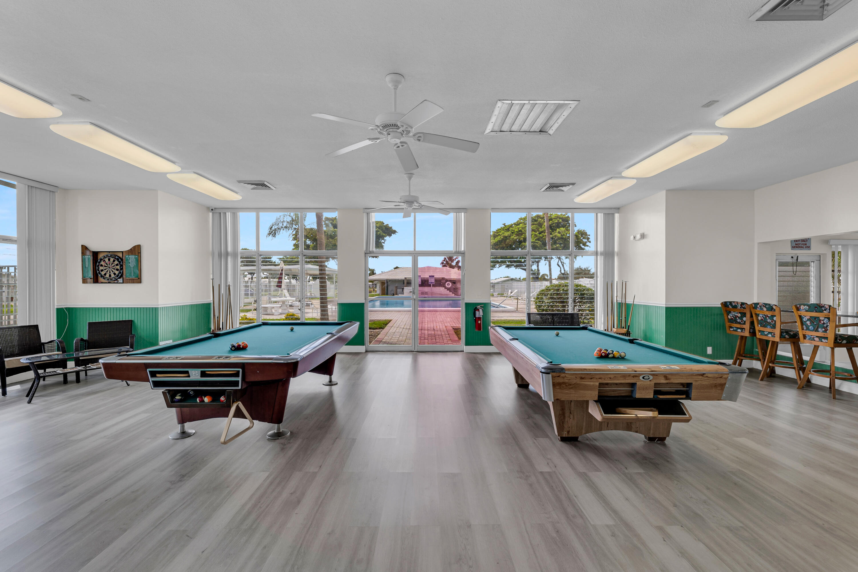 251 South Golf Boulevard, Unit 287 Pompano Beach, FL 33064 - Photo 52 of 63 a living room with furniture pool table and chairs